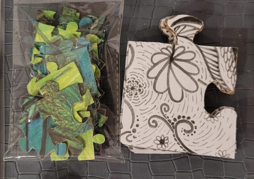 Two jigsaw puzzle sets—one green and the other black and white.